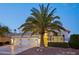 Two-story house with three-car garage, palm tree, and well-manicured landscaping at 6270 W Rose Garden Ln, Glendale, AZ 85308