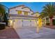 Two-story house with three-car garage, palm tree, and well-manicured landscaping at 6270 W Rose Garden Ln, Glendale, AZ 85308