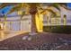 Two-story house with three-car garage, palm tree, and well-manicured landscaping at 6270 W Rose Garden Ln, Glendale, AZ 85308