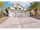 Two-story house with three-car garage and palm tree at 6270 W Rose Garden Ln, Glendale, AZ 85308