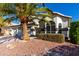 Attractive home with desert landscaping featuring a mature palm tree and manicured shrubbery at 6270 W Rose Garden Ln, Glendale, AZ 85308