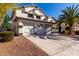 Inviting home showcasing a spacious three-car garage and appealing desert landscaping at 6270 W Rose Garden Ln, Glendale, AZ 85308