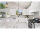 Elegant kitchen with white cabinets, a large island, and stainless steel appliances at 6270 W Rose Garden Ln, Glendale, AZ 85308