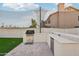 Outdoor kitchen with grill, sink, and mini-fridge at 6270 W Rose Garden Ln, Glendale, AZ 85308