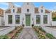 Stunning white brick home with a green door, landscaped walkway, and flowerbeds at 6737 E Exeter Blvd, Scottsdale, AZ 85251