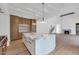 Open concept kitchen with a large marble island and views into the living room at 6737 E Exeter Blvd, Scottsdale, AZ 85251