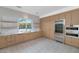 Modern kitchen with light wood cabinets, marble countertops, and stainless steel appliances at 6737 E Exeter Blvd, Scottsdale, AZ 85251