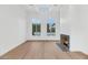 Light-filled living room with hardwood floors and fireplace, pool view at 6737 E Exeter Blvd, Scottsdale, AZ 85251