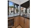 Wet bar with dark countertop, wooden cabinets, and a view of the pool at 6737 E Exeter Blvd, Scottsdale, AZ 85251