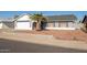 Single-story house with gray exterior, white garage door, and a palm tree in front at 7210 W Pasadena Ave, Glendale, AZ 85303