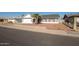 Single-story house with gray exterior, white garage door, and a palm tree in the front at 7210 W Pasadena Ave, Glendale, AZ 85303