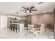 Modern kitchen with gray cabinets, white island, and a dining area at 7210 W Pasadena Ave, Glendale, AZ 85303