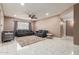 Spacious living room with gray sofas, ceiling fan, and tile flooring at 7210 W Pasadena Ave, Glendale, AZ 85303