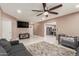 Living room with gray sofas, a view into kitchen, and a ceiling fan at 7210 W Pasadena Ave, Glendale, AZ 85303