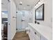 Modern bathroom with a walk-in shower and white vanity at 7480 E Sweetwater Ave, Scottsdale, AZ 85260