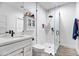 Modern bathroom with a large walk-in shower, white cabinets, and a floating vanity at 7480 E Sweetwater Ave, Scottsdale, AZ 85260