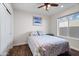 Bedroom with ceiling fan, large window, and dresser at 7480 E Sweetwater Ave, Scottsdale, AZ 85260