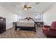 Spacious bedroom with dark wood furniture and hardwood floors at 7480 E Sweetwater Ave, Scottsdale, AZ 85260