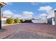 Brick driveway leading to a garage and gated entrance at 7480 E Sweetwater Ave, Scottsdale, AZ 85260