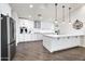 Modern kitchen with white cabinets, large island, and stainless steel appliances at 7480 E Sweetwater Ave, Scottsdale, AZ 85260