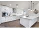 Bright white kitchen with stainless steel appliances and an island at 7480 E Sweetwater Ave, Scottsdale, AZ 85260