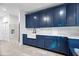 Laundry room with navy blue cabinets and a large farmhouse sink at 7480 E Sweetwater Ave, Scottsdale, AZ 85260