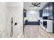 Laundry room with navy cabinets, farmhouse sink, and window at 7480 E Sweetwater Ave, Scottsdale, AZ 85260