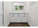 White cabinets and countertops in the laundry room at 7480 E Sweetwater Ave, Scottsdale, AZ 85260