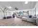 Bright living room with vaulted ceilings, L-shaped sofa, and hardwood floors at 7480 E Sweetwater Ave, Scottsdale, AZ 85260