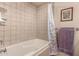 Clean bathroom with a shower/tub combo and tile surround at 7846 E Mackenzie Dr, Scottsdale, AZ 85251