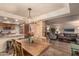 Bright dining area with a wooden table, chandelier, and open kitchen at 7846 E Mackenzie Dr, Scottsdale, AZ 85251