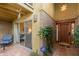 Inviting entryway with a wooden door, tiled flooring, and a view into the living area at 7846 E Mackenzie Dr, Scottsdale, AZ 85251