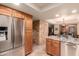 Updated kitchen featuring granite countertops, stainless steel appliances, and ample cabinet space at 7846 E Mackenzie Dr, Scottsdale, AZ 85251