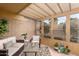 Bright sunroom with wicker furniture and glass windows at 7846 E Mackenzie Dr, Scottsdale, AZ 85251