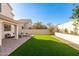 Landscaped backyard with artificial turf and patio seating area at 8134 E Rita Dr, Scottsdale, AZ 85255