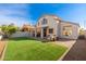 Artificial turf backyard with patio furniture and covered patio at 8134 E Rita Dr, Scottsdale, AZ 85255