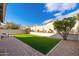 Artificial turf backyard with paved patio and seating area at 8134 E Rita Dr, Scottsdale, AZ 85255