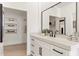 Bathroom with white vanity, black hardware, and large mirror at 8134 E Rita Dr, Scottsdale, AZ 85255