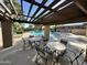 Relaxing pool area with tables, chairs, and pergola at 8625 E Belleview Pl # 1047, Scottsdale, AZ 85257