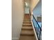 Carpeted staircase with metal railing at 8625 E Belleview Pl # 1047, Scottsdale, AZ 85257