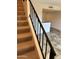 Carpeted staircase with a modern metal railing at 8625 E Belleview Pl # 1047, Scottsdale, AZ 85257