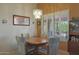 Bright dining area with wood table and chairs, and view to backyard at 9346 W Glen Oaks N Cir, Sun City, AZ 85351