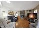 Spacious living room featuring a stone fireplace and hardwood floors at 9346 W Glen Oaks N Cir, Sun City, AZ 85351