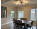 Dining room with large windows and a wood table at 9750 E Radioactive Dr, Mesa, AZ 85212