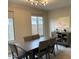 Dining room with large windows, modern light fixture, and sideboard at 9750 E Radioactive Dr, Mesa, AZ 85212