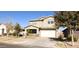 Two-story house with tan siding, attached garage, and front yard at 9750 E Radioactive Dr, Mesa, AZ 85212