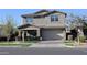 Charming two-story home featuring a well-manicured lawn and welcoming front porch at 9750 E Radioactive Dr, Mesa, AZ 85212