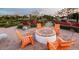 Orange Adirondack chairs around a fire pit in a community space at 9750 E Radioactive Dr, Mesa, AZ 85212