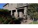 Inviting front porch featuring decorative brick accents and shade from the mature landscaping at 9750 E Radioactive Dr, Mesa, AZ 85212