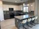 Open kitchen boasts granite counters, upgraded cabinets, and breakfast bar at 9750 E Radioactive Dr, Mesa, AZ 85212